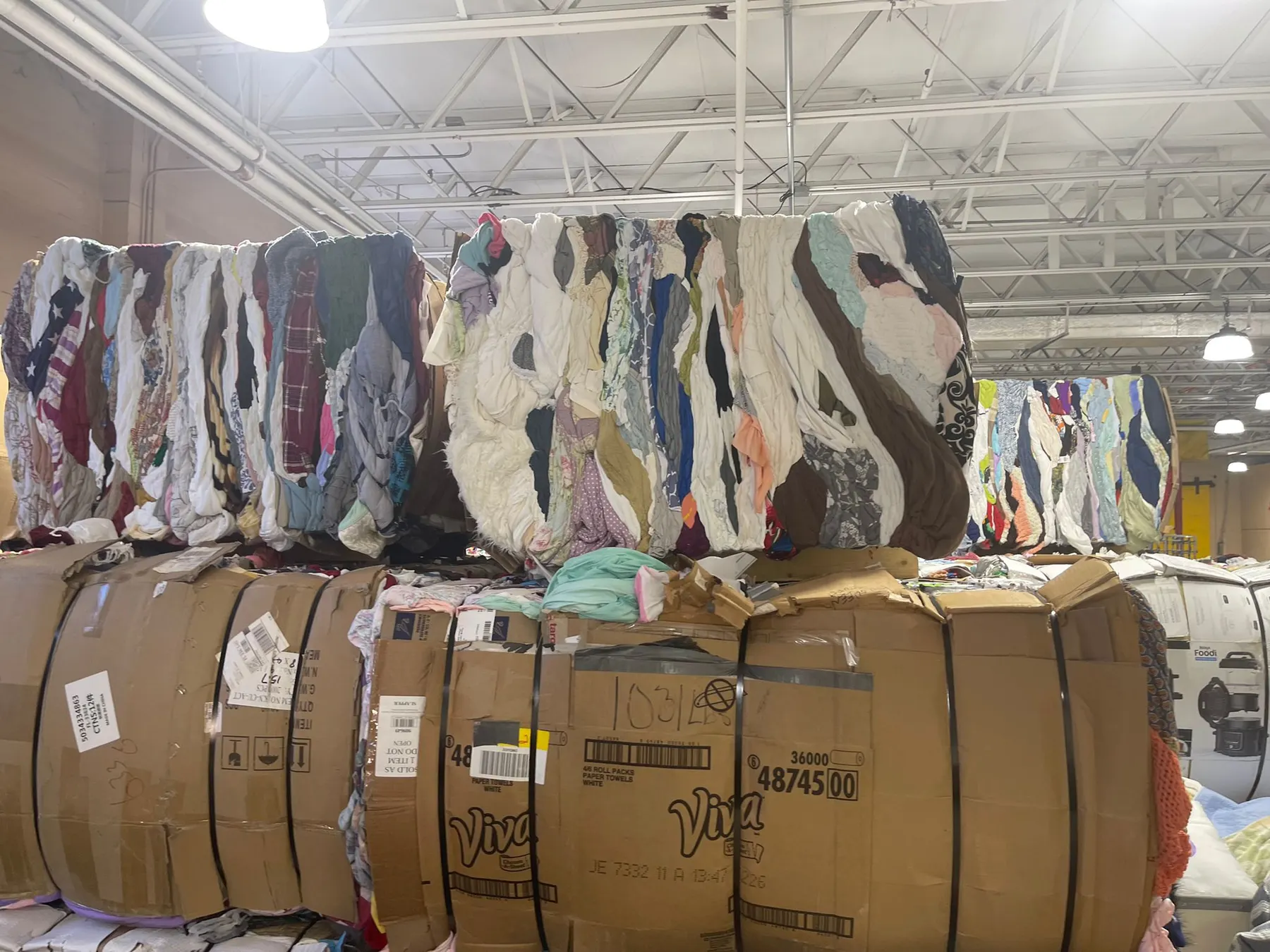 Compressed used clothing bales stacked in the warehouse